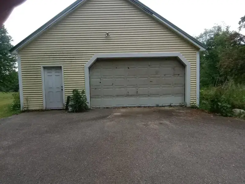 Dirty yellow siding beside a garage door, then the same wall and door cleaned